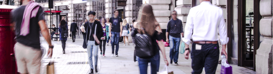 People walking down a busy shopping street in London