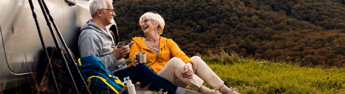 An older couple resting after a hike.