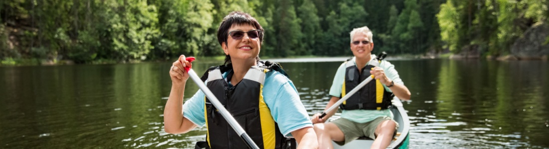 A couple on holiday taking a canoe ride.