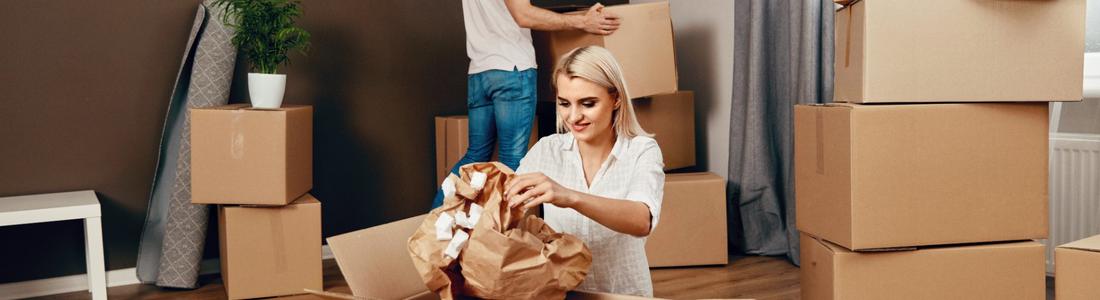 A couple unpacking boxes after moving home.