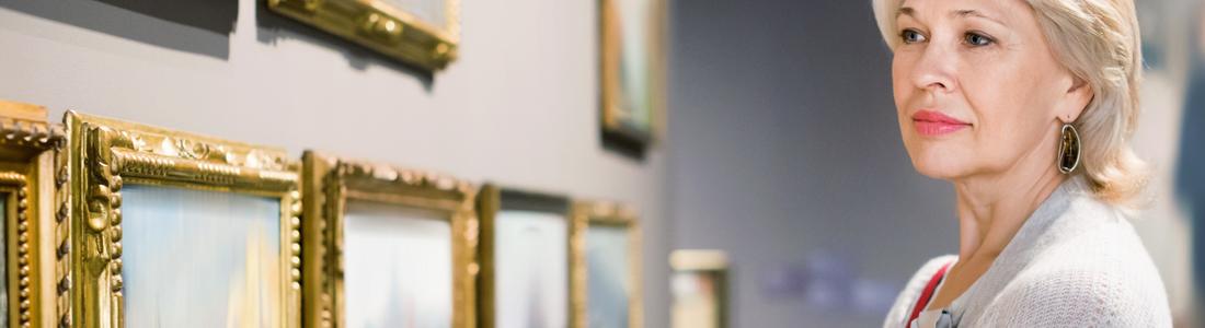 A woman looking at art in a gallery.