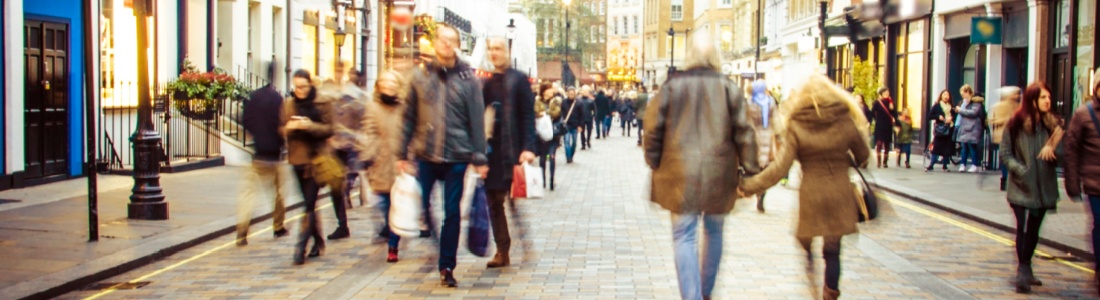 People walking down a high street.