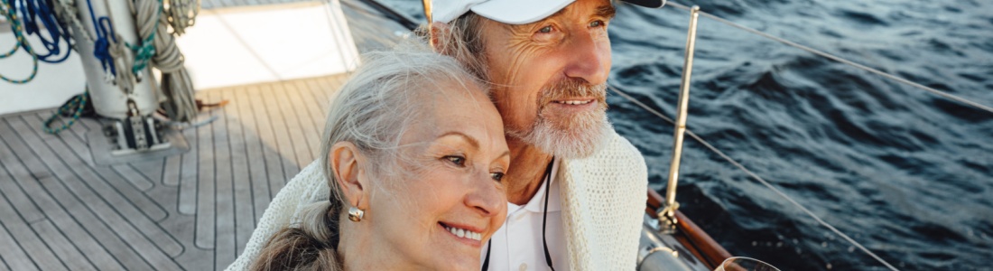 A couple sitting on a yacht deck.