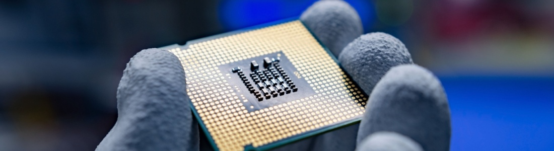 A hand holding a CPU.