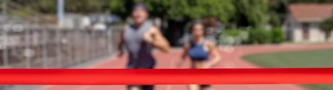 Runners running towards a finish line.