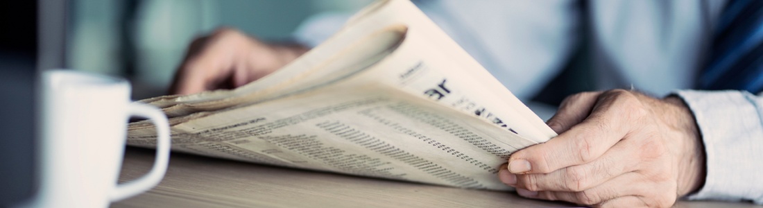 A man reading a newspaper.