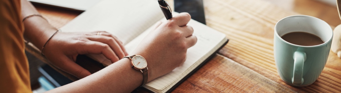 A woman making notes in a diary.