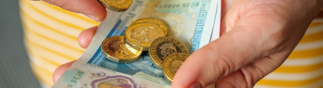 A woman holding cash in her hands.