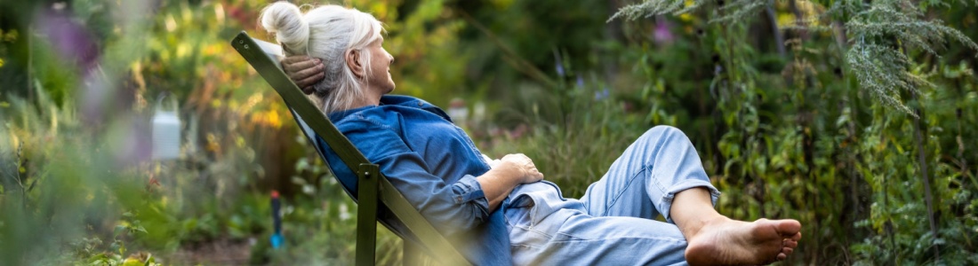 A woman relaxing in a garden.