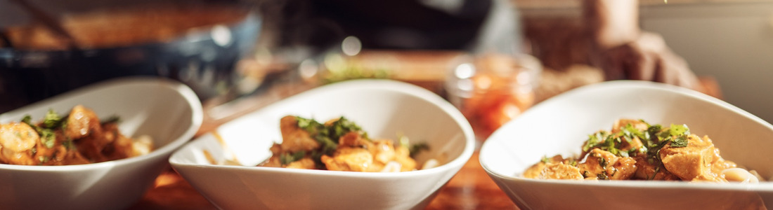 A man adding garnishes to a meal.